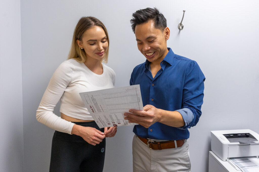 A medical provider and their patient discuss Body Sculpting near Logan Square at Balanced Flow Wellness