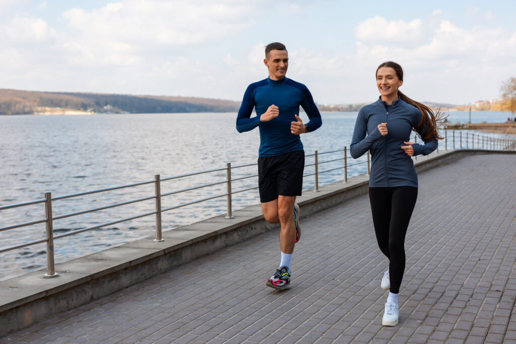 A couple going for a run to build muscle and prevent the need for urinary incontinence treatment near Chicago