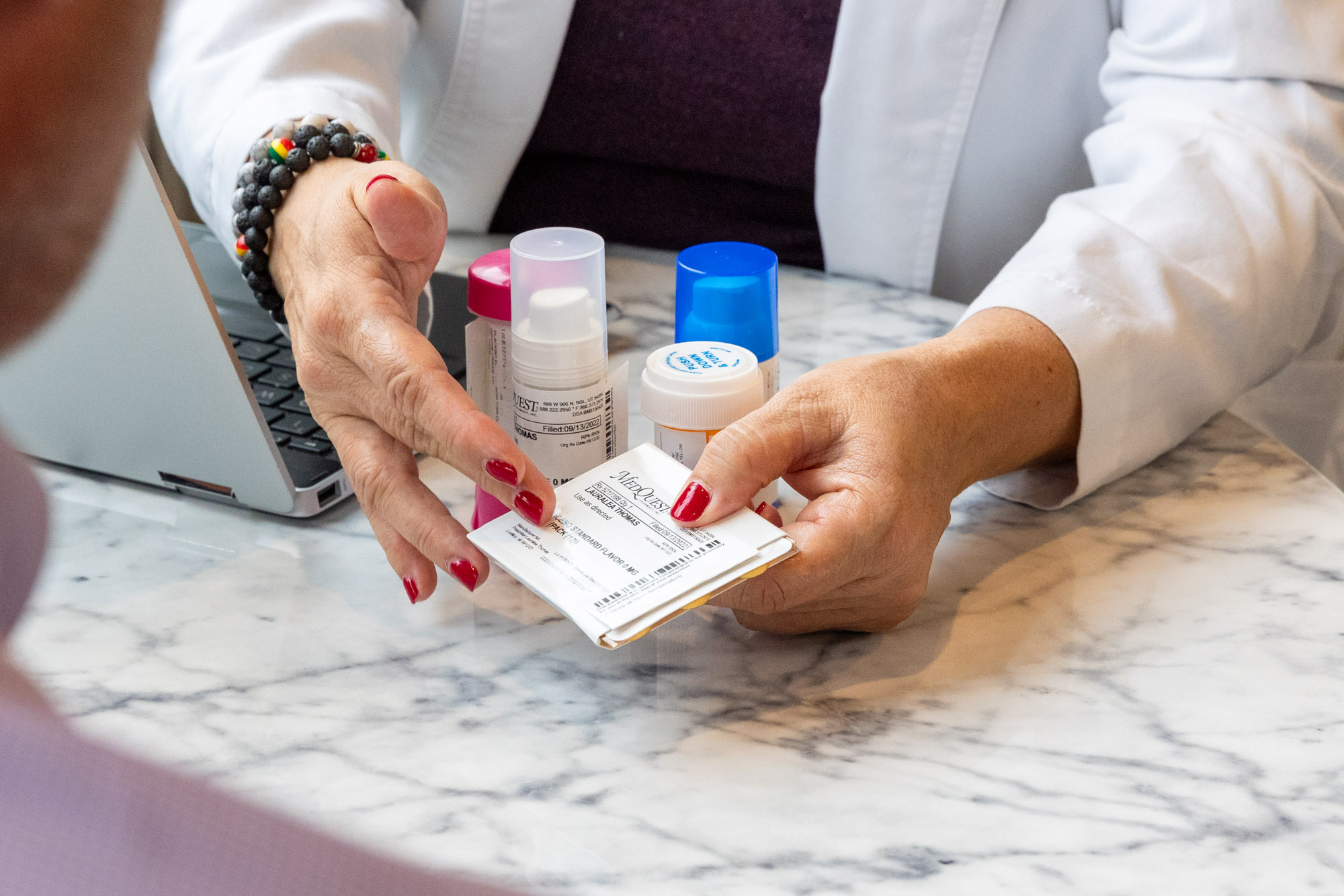 A close up of a doctor showing a patient their prescription for hormone therapy and weight loss in Chicago